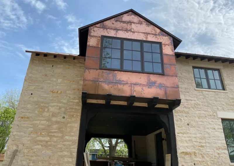 Copper metal panel facade on a stone building for Metal Roof Coating in Alvarado